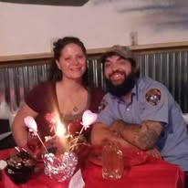 Two loved ones smiling at a table