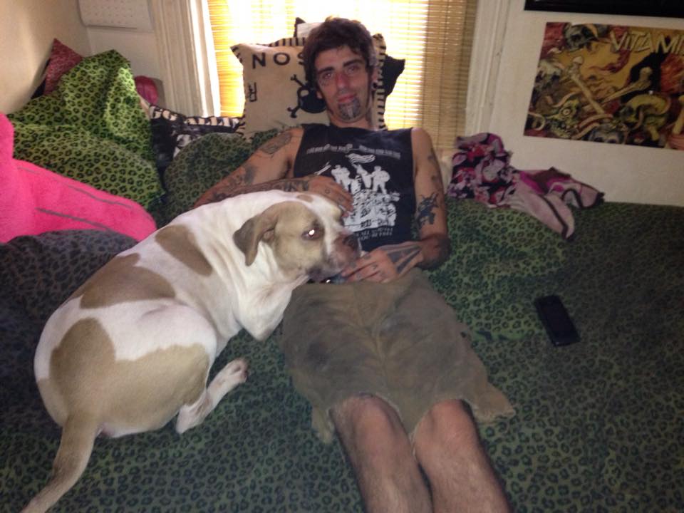 A loved one resting on a couch with a dog