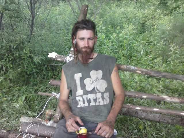 A loved one sitting with friends on the road