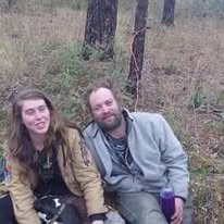 Two loved ones sitting together in the woods
