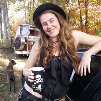 A loved one smiling outdoors with a mug