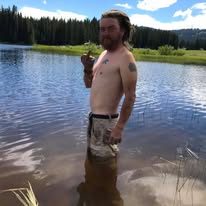 A loved one standing in water by a lake