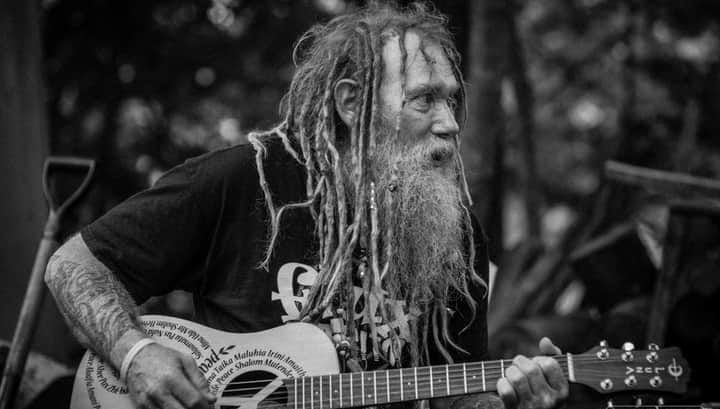 A loved one playing guitar in black and white